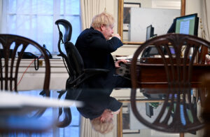 Johnson at his desk, drinking tea
