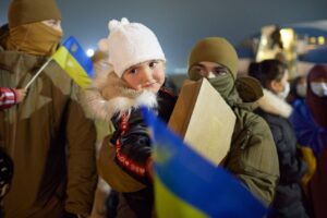Little girl refugee with Ukrainian flag